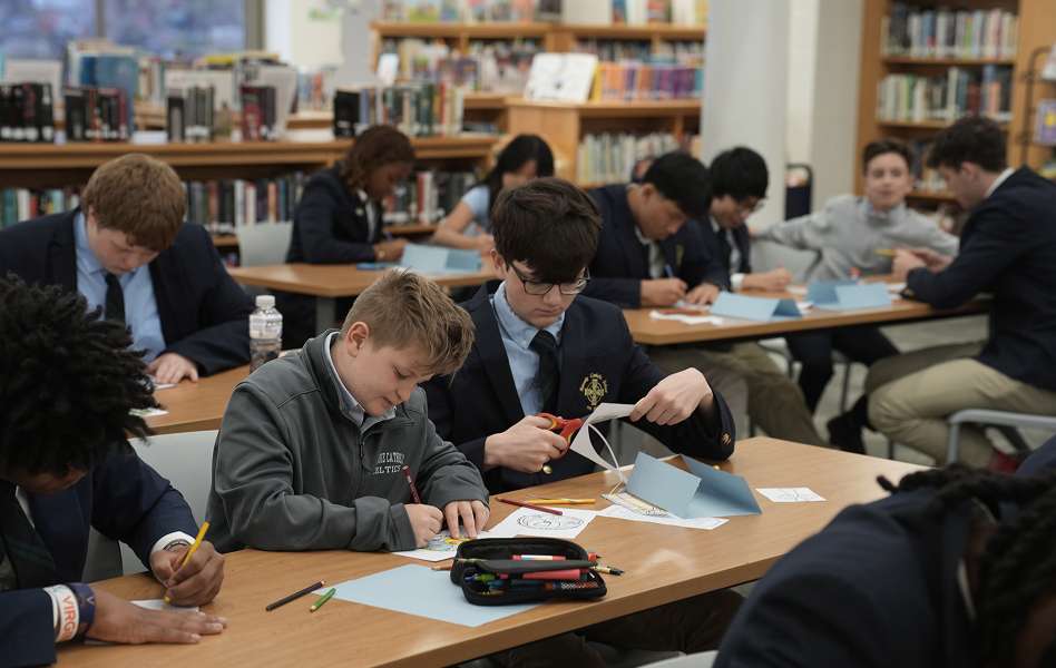 Students working on a craft project at tables in a library