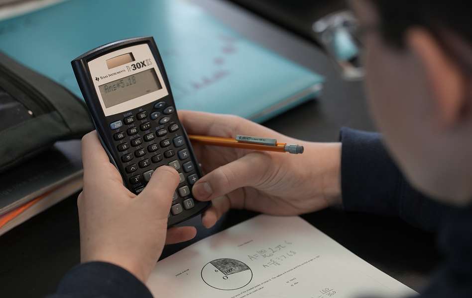 Student using a calculator while working on a math problem