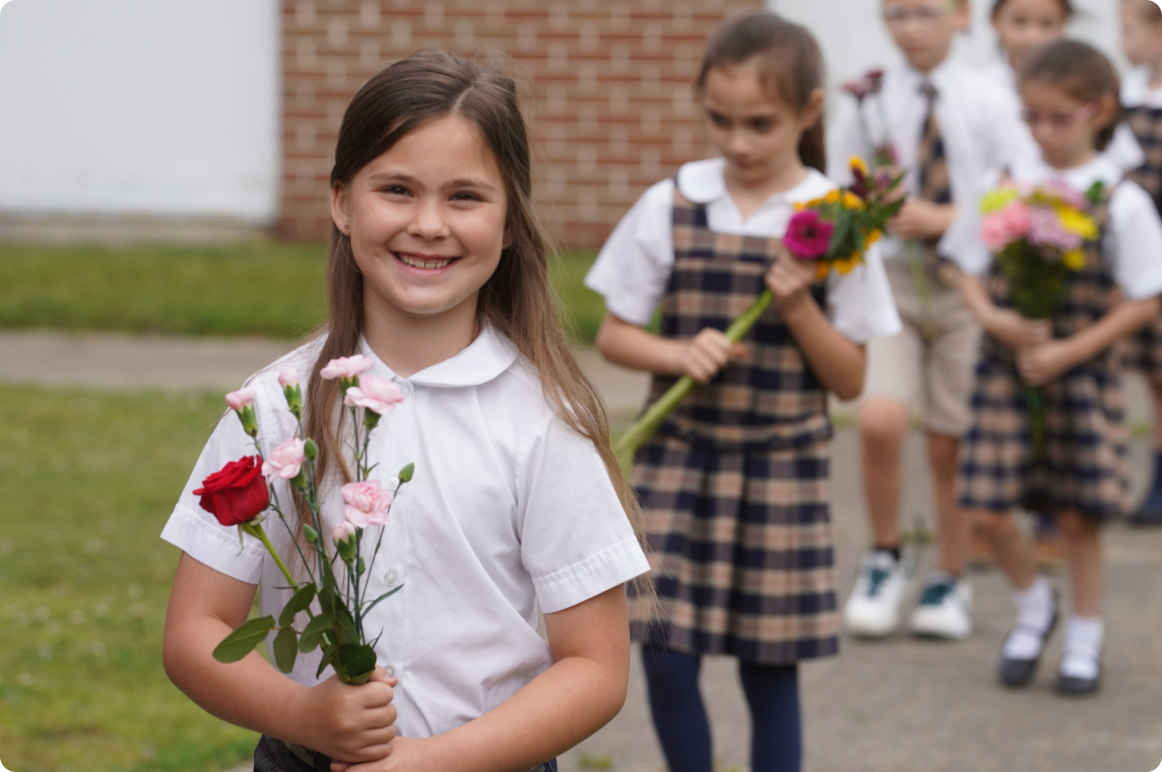 A girl smiling while holding flowers